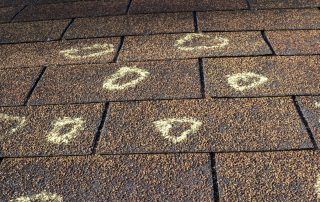 Insurance adjuster marked the hail damage on a insureds roof