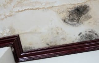 Damage caused by water leakage on a wall and ceiling