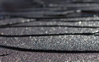 Gleaming shingle roof Shortle after rain in sunshine