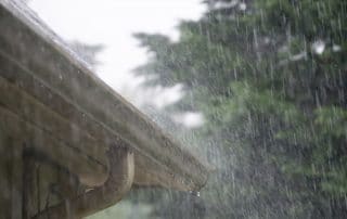 Rain pouring on residential roof