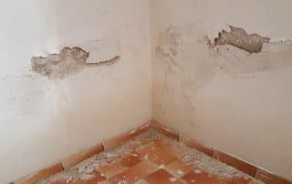 Crumbling drywall in a water damaged room