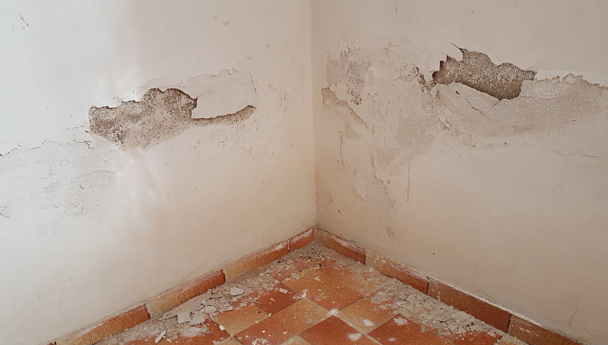 Crumbling drywall in a water damaged room