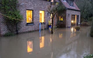 Exterior of a home with a flooded yard