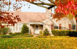 Exterior and front yard of a home with autumn trees