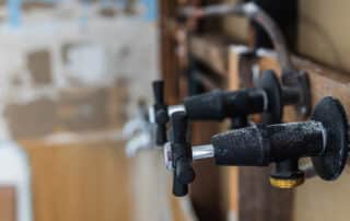 Wall with drywall cut away to repair plumbing